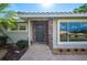 Close up of the home's front door with stone accents and manicured landscaping at 1235 Lake Point Dr, Lakeland, FL 33813