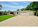 Charming home with a tile roof, beautiful landscaping, and a brick-paved driveway at 1235 Lake Point Dr, Lakeland, FL 33813