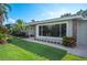Landscaped front yard with stone accents and large windows at 1235 Lake Point Dr, Lakeland, FL 33813