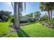 Beautiful front yard featuring tropical landscaping at 1235 Lake Point Dr, Lakeland, FL 33813