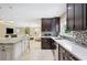 Open kitchen with a large island, stainless steel appliances, and stylish backsplash, leading into the living space at 1235 Lake Point Dr, Lakeland, FL 33813