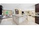Open concept kitchen showcasing a large island, flowing seamlessly into the dining and living areas at 1235 Lake Point Dr, Lakeland, FL 33813