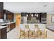 Gourmet kitchen features granite countertops, stainless steel appliances, and island with seating at 1235 Lake Point Dr, Lakeland, FL 33813