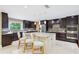 Elegant kitchen with a large island, stainless steel appliances, and pendant lighting at 1235 Lake Point Dr, Lakeland, FL 33813