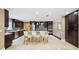 Spacious kitchen features a large island, modern appliances, dark wood cabinetry, and elegant pendant lighting at 1235 Lake Point Dr, Lakeland, FL 33813