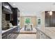 Bright kitchen and dining area featuring updated appliances, dark wood cabinetry, and a lovely view to the backyard at 1235 Lake Point Dr, Lakeland, FL 33813