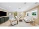 Bright living room with comfortable seating, neutral colors and a large picture window for natural light at 1235 Lake Point Dr, Lakeland, FL 33813