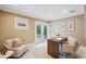 Bright home office featuring a comfortable seating area and access to a private outdoor space through double doors at 1235 Lake Point Dr, Lakeland, FL 33813