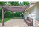 Backyard pergola-covered patio features seating and plenty of room for entertaining or relaxing by the landscaped yard at 1235 Lake Point Dr, Lakeland, FL 33813