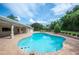 Private backyard oasis featuring a large in-ground pool with brick patio at 1235 Lake Point Dr, Lakeland, FL 33813