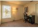 Simple bedroom with natural light, carpeted floors, and a functional workspace at 1410 Bramblewood Dr, Lakeland, FL 33811