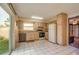 Functional kitchen with white tile floors, essential appliances, and access to the backyard at 1410 Bramblewood Dr, Lakeland, FL 33811