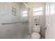 Bathroom with a glass shower featuring a toiletry niche, toilet, and small window at 1434 Country Ridge Dr, Lakeland, FL 33801