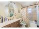 Bathroom featuring an oval mirror, vanity, and bathtub with tiled walls at 1434 Country Ridge Dr, Lakeland, FL 33801
