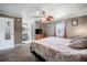 Bedroom featuring soft carpet, ceiling fan, and adjacent bathroom with a dual sink at 1434 Country Ridge Dr, Lakeland, FL 33801