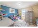 bedroom with blue accent wall, fun decor, and gray dresser at 1434 Country Ridge Dr, Lakeland, FL 33801