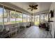 Sunroom filled with natural light, featuring a ceiling fan and patio furniture at 1434 Country Ridge Dr, Lakeland, FL 33801