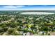 Aerial shot of the home nestled within a residential community and beautiful lake in the distance at 1825 Pawnee Trl, Lakeland, FL 33803