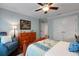 Bedroom with a comfortable blue arm chair and a wooden dresser, with a glimpse of a connecting hall at 1825 Pawnee Trl, Lakeland, FL 33803