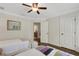 Bedroom with two beds, ceiling fan, and an ensuite bathroom and closet at 1825 Pawnee Trl, Lakeland, FL 33803