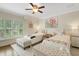 Bright bedroom featuring two beds, soft decor, a ceiling fan, and great natural light at 1825 Pawnee Trl, Lakeland, FL 33803