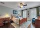 Bedroom featuring a wooden bedframe, desk, shuttered windows, and pale blue walls at 1825 Pawnee Trl, Lakeland, FL 33803