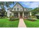 Charming two-story home featuring a welcoming front porch, manicured lawn, and lush landscaping at 1825 Pawnee Trl, Lakeland, FL 33803