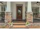 Charming front entrance with stone accents, decorative planters, and wood door at 1825 Pawnee Trl, Lakeland, FL 33803