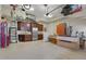 Spacious garage with storage cabinets, stainless refrigerator, and overhead bike rack at 1825 Pawnee Trl, Lakeland, FL 33803
