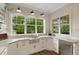 Kitchen with stainless sink, marble countertops, and bright windows at 1825 Pawnee Trl, Lakeland, FL 33803