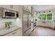 Bright kitchen with stainless steel appliances, tile backsplash, and wood floors at 1825 Pawnee Trl, Lakeland, FL 33803