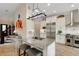 Open kitchen with island, stainless appliances, breakfast bar, and hardwood floors at 1825 Pawnee Trl, Lakeland, FL 33803