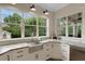 Bright kitchen with stainless sink, marble countertops, and corner windows at 1825 Pawnee Trl, Lakeland, FL 33803
