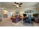 Living room with home office, dual ceiling fans, and lots of natural light at 1825 Pawnee Trl, Lakeland, FL 33803