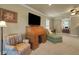 Spacious living room featuring a rolltop desk, sofa, chair, and ample lighting at 1825 Pawnee Trl, Lakeland, FL 33803