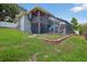 Spacious backyard featuring a multi-level patio, pool area, and lush landscaping at 1922 Matthew Ct, Lakeland, FL 33813