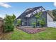 Lush backyard features a screened-in pool, multi-level deck, and well-maintained lawn at 1922 Matthew Ct, Lakeland, FL 33813