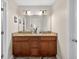 Bathroom showcasing a dual-sink vanity with granite countertop, ample space, and modern fixtures at 1922 Matthew Ct, Lakeland, FL 33813