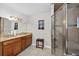 Bathroom featuring a dual-sink vanity with granite countertop and a walk-in shower at 1922 Matthew Ct, Lakeland, FL 33813