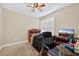 Cozy bedroom features a ceiling fan, window, and workspace for studying or working from home at 1922 Matthew Ct, Lakeland, FL 33813