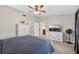 Bedroom featuring a ceiling fan, tv, and white furniture, and neutral walls at 1922 Matthew Ct, Lakeland, FL 33813