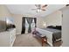Comfortable bedroom features a ceiling fan, neutral walls, and a window for natural light at 1922 Matthew Ct, Lakeland, FL 33813