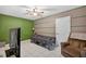 Bedroom featuring tile floors, a television, and accent wall at 1922 Matthew Ct, Lakeland, FL 33813