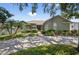 Charming single-story home with stone accents, mature landscaping, and a spacious driveway at 1922 Matthew Ct, Lakeland, FL 33813