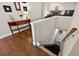 Hallway showcasing hardwood floors, a staircase, and a wooden table with decor at 1922 Matthew Ct, Lakeland, FL 33813