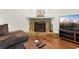 Living room with wood floors and a stone fireplace at 1922 Matthew Ct, Lakeland, FL 33813
