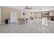 Open living space with tile floors, dining area, and access to outdoor patio at 1922 Matthew Ct, Lakeland, FL 33813