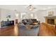Open-concept living room features wood floors and stone fireplace at 1922 Matthew Ct, Lakeland, FL 33813