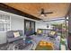 Relaxing covered patio with comfortable seating, ceiling fan, and decorative rug for outdoor living at 1922 Matthew Ct, Lakeland, FL 33813