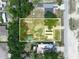Aerial view of the property, showing the home, sheds, and surrounding land in a rural setting at 2120 Dille St, Lakeland, FL 33815